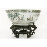 A large 18th century Chinese famille vert punch bowl, decorated inside and out with figures in a