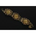 A gold seven row gate link bracelet, set with three gold sovereigns, dated 1900, 1901, 1871, all