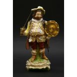 A Derby figure of Sir John Falstaff,standing on a naturalistic base, with applied gilt metal