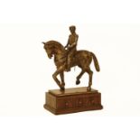 A reproduction bronzed figure of a uniformed man on horseback, on a three drawer base, 102cm high