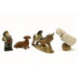 A Beswick figure of a man pushing a donkey, 10cm high, together with a Dachschund and one other, and