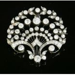 A Belle Époque diamond set brooch/pendant, c.1915,of rounded palmette form. Radiating blade edge