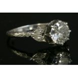 An Edwardian single stone diamond ring, c.1910-1915,with diamond set shoulders. An old brilliant cut