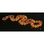 A single row graduated amber bead necklace,to a later four-row marcasite clasp. Graduated bouton-