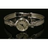 A ladies' 9ct white gold, diamond set, Swiss cocktail watch, c.1960,on a later 9ct white gold