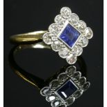 An Art Deco sapphire and diamond offset square cluster ring, c.1920,a square step cut sapphire,