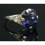 An Art Deco single stone sapphire ring with diamond set shoulders,a cushion-shaped, mixed cut,