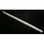 An Art Deco graduated diamond and synthetic sapphire line bracelet,with a central row of graduated