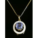 A single stone sapphire and enamel pendant, c.1915,with an oval mixed cut sapphire, estimated as