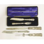 Two pairs of carving sets and a bread knife,one cased set with shaped handles, shell and scroll