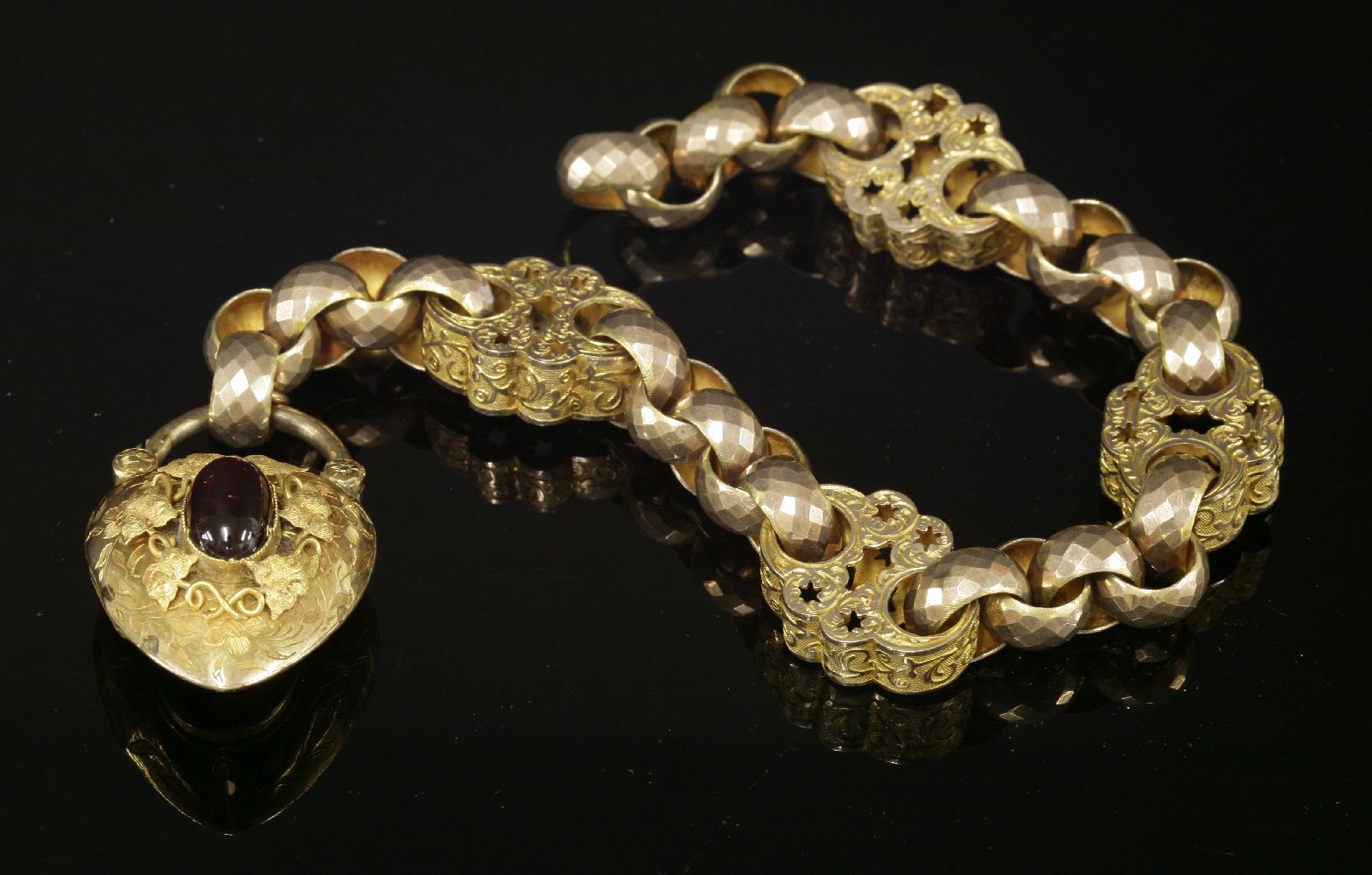 A Victorian gold bracelet,with garnet set padlock clasp, The bracelet composed of sections of