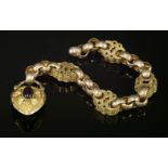 A Victorian gold bracelet,with garnet set padlock clasp, The bracelet composed of sections of