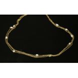 An Edwardian gold cabochon opal set long chain, later converted to a three row necklace. A series of