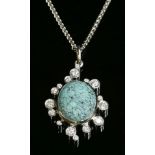 A platinum, turquoise matrix and diamond cluster pendant,with an oval cabochon turquoise matrix, rub