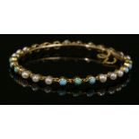 A late Victorian turquoise and split pearl hinged bangle, c.1900,a solid chain-link bangle with sets