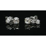 A pair of 18ct white gold, two stone diamond drop earrings, with an old European cut diamond, four