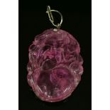 A Chinese carved pink tourmaline pendant,depicting peaches and foliage to a later hinged wire