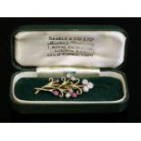A two-colour gold, diamond, ruby and emerald spray brooch, c.1945-1955,a scrolling wire spray with a