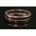 An Art Deco white gold ruby eternity ring, c.1925,with a row of calibré cut rubies, channel set to a