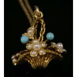 A gold, split pearl and turquoise giardinetti pendant, c.1900,with a woven wire basket set with