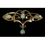 A gold, Art Nouveau, opal set bar brooch,of open whiplash form. Scrolling tapered sections with