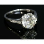 A single stone diamond ring,with diamond set shoulders, with an old brilliant cut diamond double