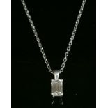 A platinum single stone diamond pendant,with an emerald cut diamond, estimated as approximately 0.