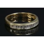 An 18ct gold diamond set half eternity ring,with a row of baguette cut diamonds, all channel set