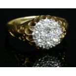 An Edwardian diamond cluster ring,with a central old European cut diamond surrounded by old Swiss