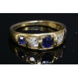 An 18ct gold, Victorian, five stone sapphire and diamond tapered band ring,with an oval old Swiss