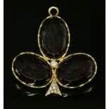 A Victorian gold, garnet and diamond set trefoil clover or shamrock brooch/pendant,composed of three