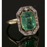 An Art Deco green paste and diamond cluster ring,with an emerald cut green paste, milligrain set