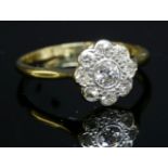 An Edwardian diamond set daisy cluster ring,with an old European cut diamond rub set to the centre