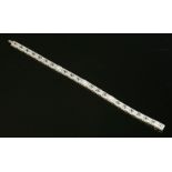 An American Art Deco three stone diamond bracelet,with a series of pierced, milligrain rectangular