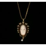 An American shell cameo and split pearl pendant, c.1900,on a modern gold box chain. The elongated