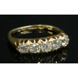 An Edwardian gold graduated five stone diamond ring,with graduated old European cut diamonds claw