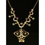 An Edwardian peridot, pink tourmaline and split pearl gold necklace, c.1910,with a centrepiece of