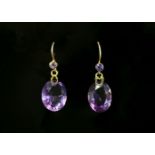 A pair of Edwardian amethyst drop earrings,with a circular mixed cut amethyst, rub set in a plain