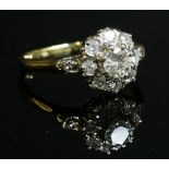 A diamond set cluster ring,with diamond set shoulders and a central brilliant cut diamond, estimated