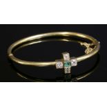 An Edwardian emerald and diamond cinquefoil cluster bangle, c.1905,a hollow tubular section hinged