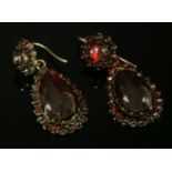 A pair of Victorian Bohemian gilt metal garnet drop earrings,composed of a circular cabochon garnet,