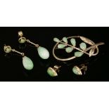 A pair of gold and jade drop earrings,with a circular cabochon jade, claw set to an open frame,