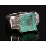 A 14ct white gold, emerald and diamond ring,with a square emerald cut emerald, four claw set at