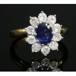 An 18ct two colour gold, sapphire and diamond oval cluster ring,with an oval mixed cut sapphire claw