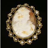 A late Victorian diamond set shell cameo brooch,depicting the profile of a lady in a light cream and