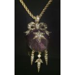 A Victorian amethyst and diamond pendant, c.1860,suspended on a gold rope chain. An oval cabochon