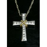 An 18ct yellow and white gold diamond set cross,a tapering Latin cross with brilliant cut diamonds