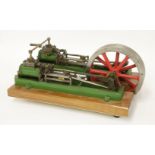 A model horizontal twin-pump steam engine,in green livery, mounted on an hardwood base,34cm long