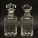 A pair of Baccarat whisky decanters,with angular mushroom stoppers and subtle thumb print details,