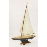 A Star Class model pond yacht, fully rigged, with a blue hull, 93cm long, on stand